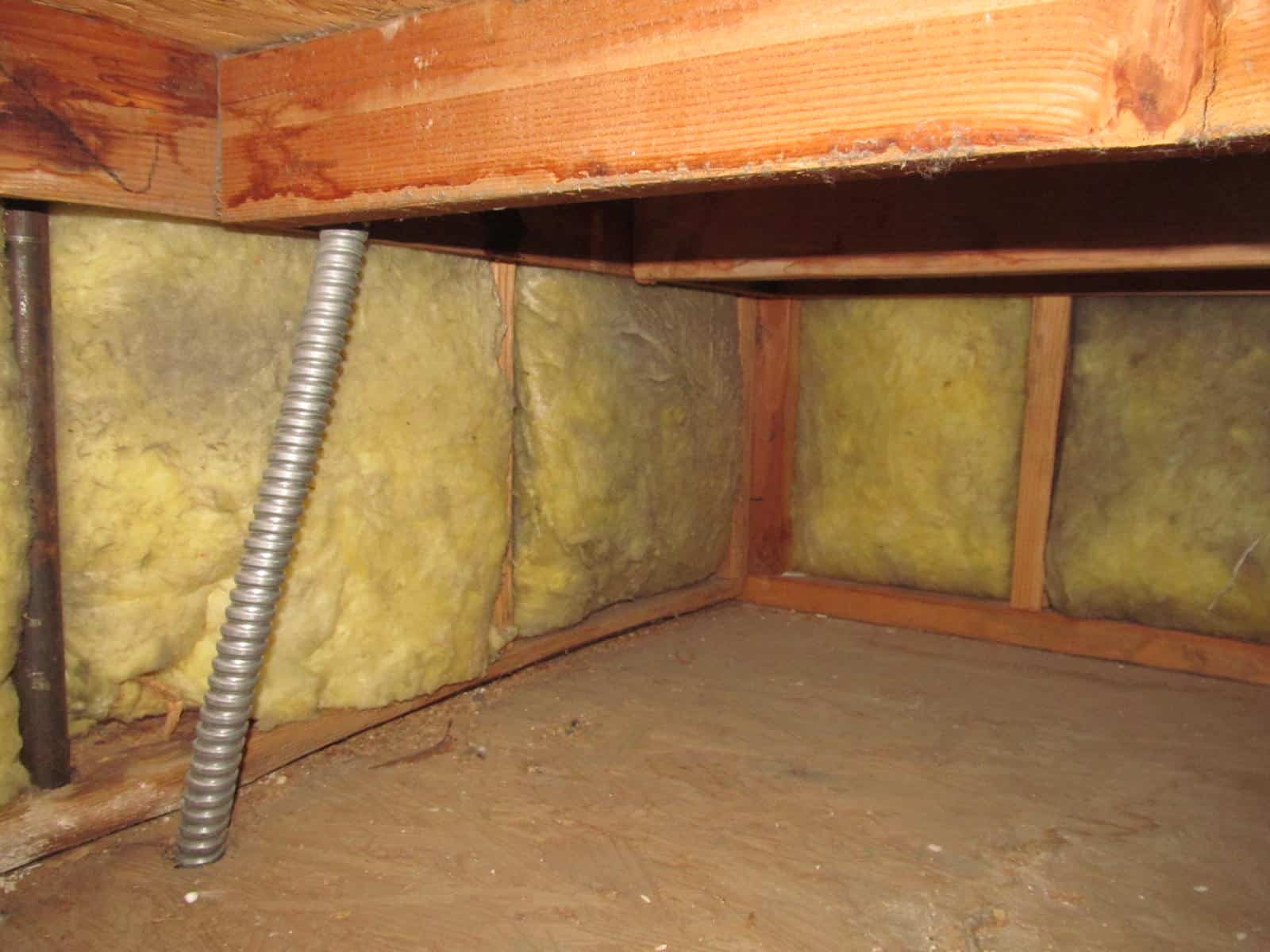 Fiberglass insulation exposed in plenum area