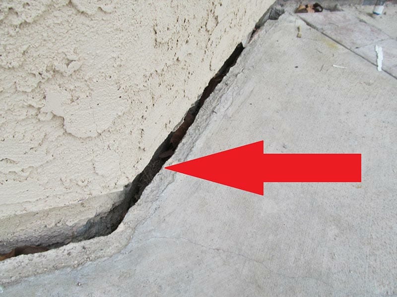 Slope creep evidenced by patio slab pulled away from foundation